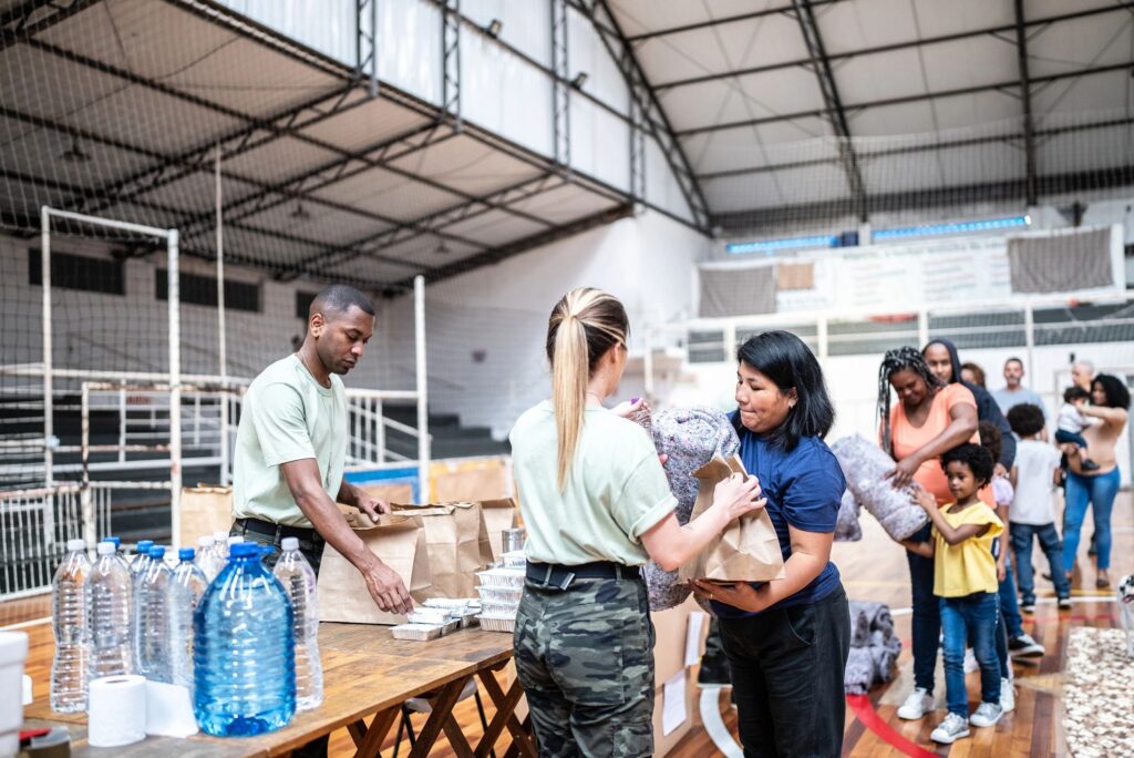 Soldiers giving donations to refugees in a sheltering