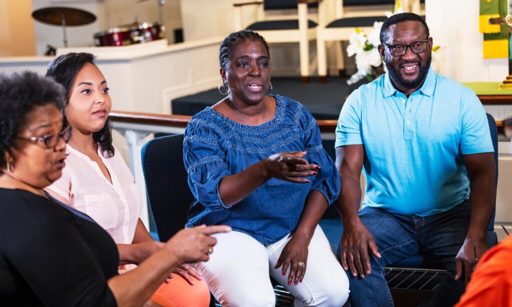 Group of black men and women in circle having discussion
